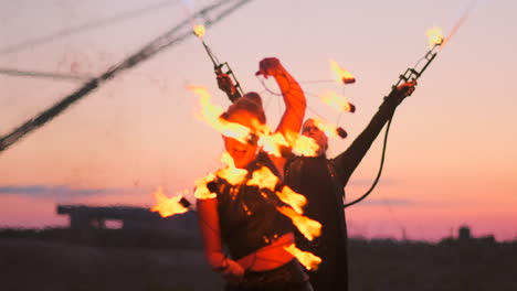 A-group-of-professional-circus-performers-with-fire-shows-dance-shows-in-slow-motion-using-flame-throwers-and-rotating-the-torches-burning-objects